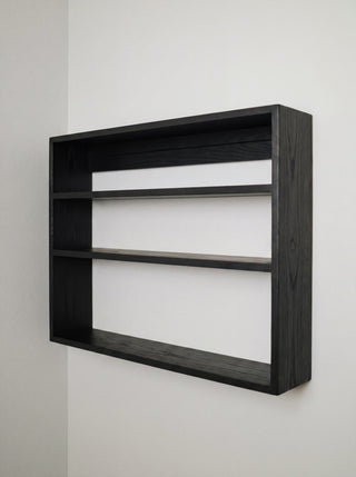 Monolith Wall Shelf in black oak, alternate angle showing dark grain detail