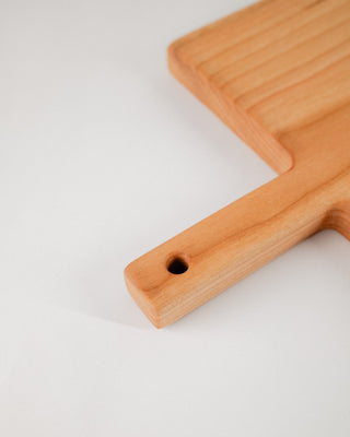 Wooden cutting board with a handle on a white background